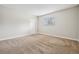 Neutral bedroom offers a calm retreat with large window and plush carpeting at 205 Wright St # 104, Lakewood, CO 80228