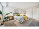 A cozy bedroom featuring neutral tones, a plush bed with patterned bedding, and modern decor at 205 Wright St # 104, Lakewood, CO 80228