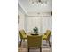 A dining area features a glass table with four chairs and white closet doors, illuminated by modern track lighting at 205 Wright St # 104, Lakewood, CO 80228