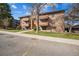 Exterior view of apartments, with wood siding, patios, and landscaping from the parking lot at 205 Wright St # 104, Lakewood, CO 80228
