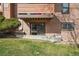 Exterior view of building featuring patios, wood siding, and well-maintained landscaping at 205 Wright St # 104, Lakewood, CO 80228