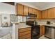 A kitchen view connects to a living area, showcasing wood cabinets and stone accents at 205 Wright St # 104, Lakewood, CO 80228