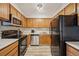 A functional kitchen features wood cabinets, stainless steel appliances, and modern countertops at 205 Wright St # 104, Lakewood, CO 80228