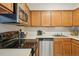 Bright kitchen showcasing stainless steel appliances, wood cabinets, and sleek countertops at 205 Wright St # 104, Lakewood, CO 80228