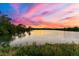 Picturesque sunset reflecting over tranquil lake, fringed by lush greenery, creating a serene atmosphere at 205 Wright St # 104, Lakewood, CO 80228