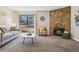 Inviting living room featuring a stone fireplace and sliding glass doors to outdoor space at 205 Wright St # 104, Lakewood, CO 80228