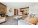 Open concept living room with stone fireplace and eat-in kitchen at 205 Wright St # 104, Lakewood, CO 80228