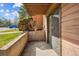 Private outdoor patio with sliding glass door and concrete retaining wall at 205 Wright St # 104, Lakewood, CO 80228
