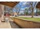 Patio with views of grassy area, parking, and mature trees for shaded relaxation at 205 Wright St # 104, Lakewood, CO 80228
