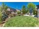 Expansive backyard featuring a lush lawn, patio area with seating, and mature trees for privacy at 110 Ferris Ln, Erie, CO 80516