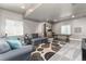 Finished basement offering a comfortable living space with plush seating and a dining area at 110 Ferris Ln, Erie, CO 80516