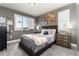 Comfortable bedroom with gray walls, plush carpeting, and a decorative shuttered window at 110 Ferris Ln, Erie, CO 80516
