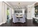Bright dining area features a rustic chandelier, stylish table, and views of the yard at 110 Ferris Ln, Erie, CO 80516