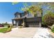 Beautiful two-story home with gray siding, covered porch, attached garage, and landscaped front yard at 110 Ferris Ln, Erie, CO 80516