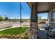 Cozy front porch with stone columns and comfortable seating overlooking the lush, green lawn at 110 Ferris Ln, Erie, CO 80516