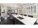 Kitchen features a spacious countertop island, stainless steel fixtures, and backyard access at 110 Ferris Ln, Erie, CO 80516