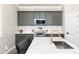 Kitchen features stainless steel appliances, subway tile backsplash, and painted cabinets at 110 Ferris Ln, Erie, CO 80516