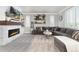 Warm and inviting living room with a stone fireplace, gray sectional sofa, and ample natural light at 110 Ferris Ln, Erie, CO 80516
