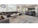 Elegant living room with a gray sectional sofa, dining area, and stylish decor at 110 Ferris Ln, Erie, CO 80516