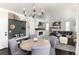 Charming open-concept living area with fireplace, kitchen, and dining area for easy entertaining at 110 Ferris Ln, Erie, CO 80516