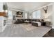 Comfortable living room with a large sectional sofa, decorative shelves, and bright, natural light at 110 Ferris Ln, Erie, CO 80516
