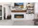 Modern living room featuring a stylish fireplace with a wooden mantel and a wall-mounted television at 110 Ferris Ln, Erie, CO 80516
