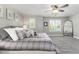 Comfortable main bedroom with a large bed, plush pillows, ceiling fan, and serene windows at 110 Ferris Ln, Erie, CO 80516