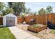 Backyard features a shed, garden, and play area at 1800 S Tennyson St, Denver, CO 80219