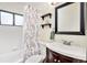 Full bathroom with shower/tub combo and floral shower curtain at 1800 S Tennyson St, Denver, CO 80219