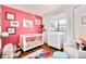 Adorable Bedroom featuring a crib, changing table, and playful decor at 1800 S Tennyson St, Denver, CO 80219