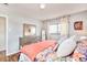 Bedroom with coral bedding and hardwood floors at 1800 S Tennyson St, Denver, CO 80219