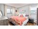 Bedroom with a coral colored bedspread and hardwood floors at 1800 S Tennyson St, Denver, CO 80219