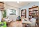 Home office with built-in bookshelves and comfortable seating at 1800 S Tennyson St, Denver, CO 80219