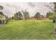 Expansive backyard features a large lawn, mature trees, and a shared fence at 12010 E Harvard Ave, Aurora, CO 80014