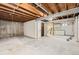 Unfinished basement with exposed beams and concrete walls awaiting your creative design at 12010 E Harvard Ave, Aurora, CO 80014