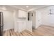 Basement area featuring recessed lighting, updated flooring, and a small bar area at 12010 E Harvard Ave, Aurora, CO 80014