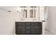 This bathroom features a double vanity, tiled floors, and lots of lighting at 12010 E Harvard Ave, Aurora, CO 80014