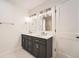 A bathroom featuring a double vanity, tiled floors, and a shower and tub combination at 12010 E Harvard Ave, Aurora, CO 80014
