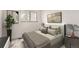 This staged bedroom has a leafy potted plant, a window, and artwork on the walls at 12010 E Harvard Ave, Aurora, CO 80014