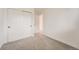 Bright bedroom featuring neutral carpet, fresh white walls, and a convenient closet at 12010 E Harvard Ave, Aurora, CO 80014