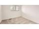 This small bedroom has neutral carpet and paint, a window, and a baseboard heater at 12010 E Harvard Ave, Aurora, CO 80014