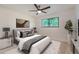 Bright bedroom featuring a ceiling fan, white walls, and a patterned rug, creating a cozy and modern space at 12010 E Harvard Ave, Aurora, CO 80014