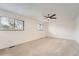 Bright bedroom with neutral carpet, two windows, and a ceiling fan offering a blank canvas at 12010 E Harvard Ave, Aurora, CO 80014