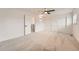 This spacious bedroom has neutral carpet, a ceiling fan, closet space, and an exit to the hall at 12010 E Harvard Ave, Aurora, CO 80014