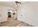 Open dining area with views of the kitchen featuring modern appliances and light-colored wood flooring at 12010 E Harvard Ave, Aurora, CO 80014