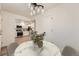 Charming dining area with modern chandelier adjacent to the well-appointed kitchen featuring stainless steel appliances at 12010 E Harvard Ave, Aurora, CO 80014