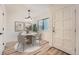 Cozy dining room features an elegant light fixture, light walls and a circular table for intimate gatherings at 12010 E Harvard Ave, Aurora, CO 80014
