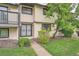 Exterior showing a covered porch, lawn, mature shrubbery and a large shade tree at 12010 E Harvard Ave, Aurora, CO 80014