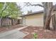 Side exterior showing private entry with yard featuring bark mulch and concrete border at 12010 E Harvard Ave, Aurora, CO 80014