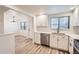 Updated kitchen boasts stainless steel appliances, white cabinets, and durable countertops at 12010 E Harvard Ave, Aurora, CO 80014